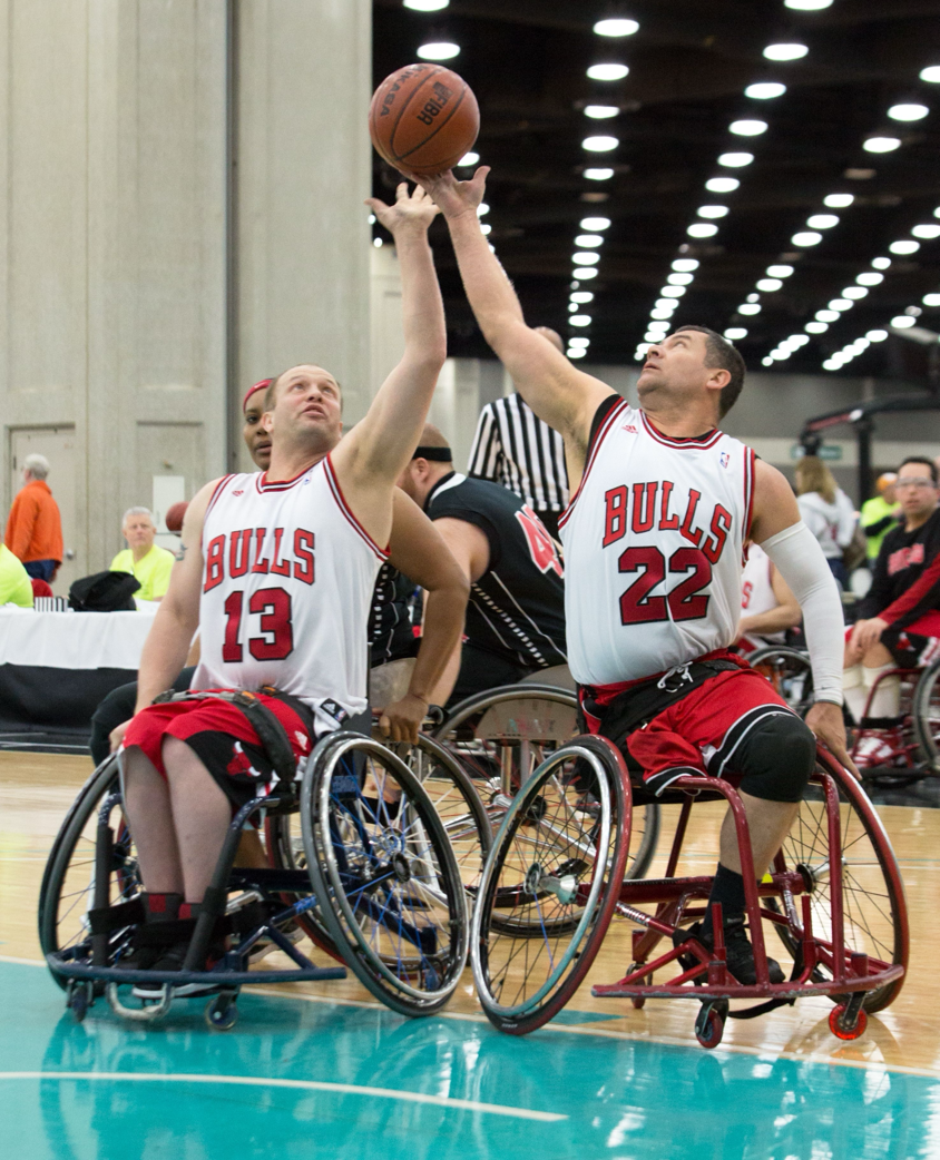Exciting wheelchair basketball game showcasing talent and teamwork indoors.