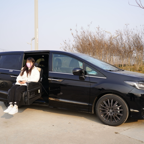 Woman in face mask using sliding seat in black car with nearby wheelchair.